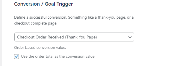 Screenshot of a web interface for setting a conversion or goal trigger with an option to define a successful conversion as a checkout order received thank you page and an option to use the order total as the conversion value.